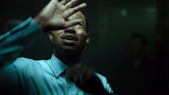 Movie still from “Escape Room” (2019), directed by Adam Robitel – A person holding his hand up; Close Up shot, High angle