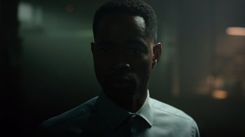 Movie still from “Escape Room” (2019), directed by Adam Robitel – A person wearing a dress shirt and tie; Close Up shot, Low angle