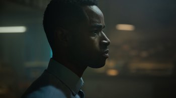 Movie still from “Escape Room” (2019), directed by Adam Robitel – A person wearing a shirt and tie; Close Up shot, Over the shoulder angle