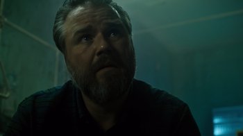 Movie still from “Escape Room” (2019), directed by Adam Robitel – A person with a goatee; Close Up shot, Low angle