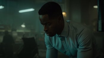 Movie still from “Escape Room” (2019), directed by Adam Robitel – A man in a white dress shirt is looking down at the ground; Close Up shot, Over the shoulder angle