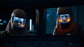Movie still from “Escape Room” (2019), directed by Adam Robitel – A man with a helmet is reflected in a mirror; Medium shot, Low angle