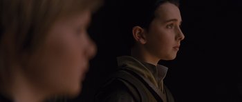 Movie still from “Thor” (2011), directed by Kenneth Branagh – A young man looking into the distance while another man looks on; Close Up shot, Over the shoulder angle