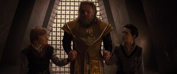 Movie still from “Thor” (2011), directed by Kenneth Branagh – A man with a beard wearing a gold and black outfit; Medium shot, Low angle