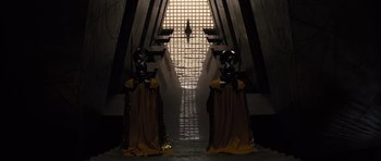 Movie still from “Thor” (2011), directed by Kenneth Branagh – Two statues in front of an entrance to a building; Extreme Wide shot, Low angle