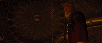 Movie still from “Thor” (2011), directed by Kenneth Branagh – An old man with long white beard standing under an umbrella; Medium shot, Low angle