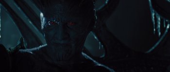 Movie still from “Thor” (2011), directed by Kenneth Branagh – A man's face with red glowing eyes; Close Up shot, Over the shoulder angle
