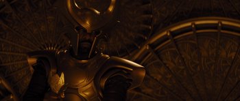 Movie still from “Thor” (2011), directed by Kenneth Branagh – A statue of a man dressed as loki; Medium shot, Low angle