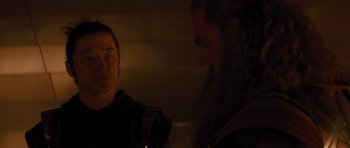 Movie still from “Thor” (2011), directed by Kenneth Branagh – A man with a beard is talking to another man with headphones; Close Up shot, Over the shoulder angle