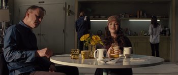 Movie still from “Thor” (2011), directed by Kenneth Branagh – A woman sitting at a table with a stack of pancakes; Medium shot, Over the shoulder angle