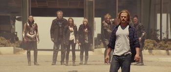 Movie still from “Thor” (2011), directed by Kenneth Branagh – A group of people standing on a street; Wide shot, Low angle