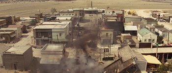 Movie still from “Thor” (2011), directed by Kenneth Branagh – An aerial view of a street with smoke billowing out of it; Extreme Wide shot, High angle