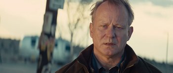 Movie still from “Thor” (2011), directed by Kenneth Branagh – An older man is looking at the camera; Close Up shot, Over the shoulder angle