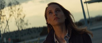 Movie still from “Thor” (2011), directed by Kenneth Branagh – A woman looking up into the sky while standing on a hill; Close Up shot, Low angle