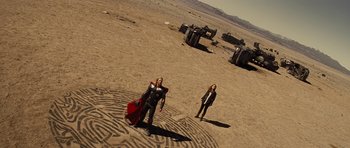Movie still from “Thor” (2011), directed by Kenneth Branagh – Two women in costumes standing in the desert; Extreme Wide shot, Overhead angle