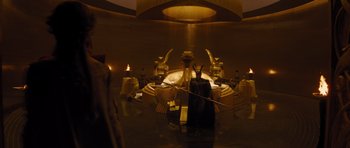 Movie still from “Thor” (2011), directed by Kenneth Branagh – A man in a costume stands in front of a fountain; Wide shot, High angle