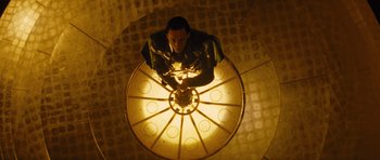 Movie still from “Thor” (2011), directed by Kenneth Branagh – A man sitting on top of a light fixture; Medium shot, Overhead angle