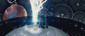 Movie still from “Thor” (2011), directed by Kenneth Branagh – A man in a green robe standing in front of a light; Wide shot, Low angle