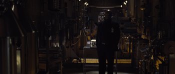 Movie still from “Thor” (2011), directed by Kenneth Branagh – A man standing in a dark room; Medium shot, Low angle