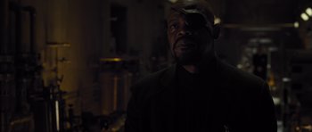 Movie still from “Thor” (2011), directed by Kenneth Branagh – A man in a black jacket and a brown hat; Close Up shot, Over the shoulder angle