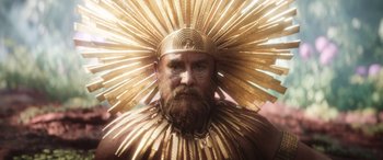 Movie still from “Thor: Love and Thunder” (2022), directed by Taika Waititi – A man with a beard wearing a gold headdress; Close Up shot, Overhead angle