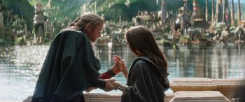 Movie still from “Thor: Love and Thunder” (2022), directed by Taika Waititi – Two women standing next to each other near a body of water; Medium shot, Over the shoulder angle