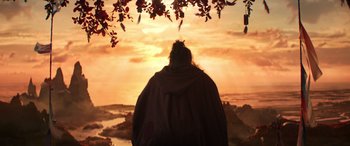 Movie still from “Thor: Love and Thunder” (2022), directed by Taika Waititi – A person standing in front of a sunset; Wide shot, Low angle