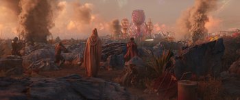 Movie still from “Thor: Love and Thunder” (2022), directed by Taika Waititi – Two people are standing on a rocky hill; Extreme Wide shot, Low angle