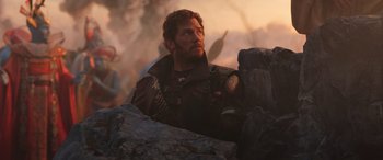 Movie still from “Thor: Love and Thunder” (2022), directed by Taika Waititi – A man is standing next to some rocks; Medium shot, Over the shoulder angle