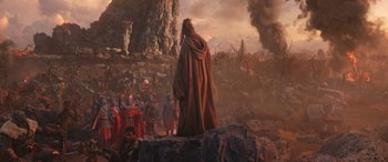 Movie still from “Thor: Love and Thunder” (2022), directed by Taika Waititi – An image of a man standing on top of a mountain; Extreme Wide shot, Over the shoulder angle