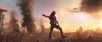 Movie still from “Thor: Love and Thunder” (2022), directed by Taika Waititi – A man standing on top of a rock in the middle of a field; Wide shot, Low angle