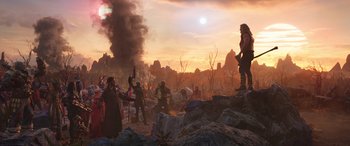 Movie still from “Thor: Love and Thunder” (2022), directed by Taika Waititi – A group of people standing on top of a hill; Wide shot, Over the shoulder angle