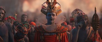 Movie still from “Thor: Love and Thunder” (2022), directed by Taika Waititi – A man in a red and blue costume with a crown; Medium shot, High angle