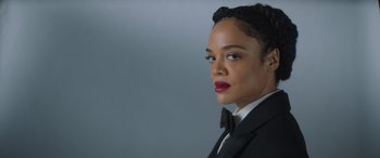 Movie still from “Thor: Love and Thunder” (2022), directed by Taika Waititi – A person wearing a suit and tie; Close Up shot, Low angle