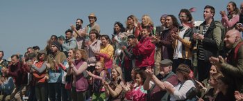 Movie still from “Thor: Love and Thunder” (2022), directed by Taika Waititi – A group of people standing in front of each other clapping; Wide shot, High angle