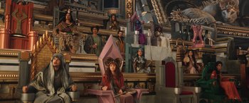 Movie still from “Thor: Love and Thunder” (2022), directed by Taika Waititi – A woman sitting on top of a pink throne; Extreme Wide shot, High angle