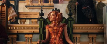 Movie still from “Thor: Love and Thunder” (2022), directed by Taika Waititi – A woman in a costume sitting on a throne; Medium shot, Low angle