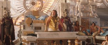 Movie still from “Thor: Love and Thunder” (2022), directed by Taika Waititi – A man dressed as a greek god in a museum; Wide shot, Low angle