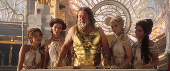 Movie still from “Thor: Love and Thunder” (2022), directed by Taika Waititi – A group of people standing next to each other in a room; Medium shot, Low angle