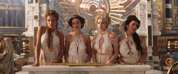 Movie still from “Thor: Love and Thunder” (2022), directed by Taika Waititi – A group of women standing next to each other in dresses; Medium shot, Low angle