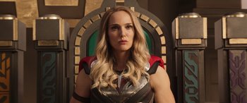 Movie still from “Thor: Love and Thunder” (2022), directed by Taika Waititi – A woman with blonde long hair wearing a thor costume; Close Up shot, Low angle