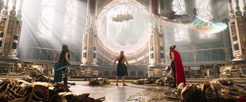 Movie still from “Thor: Love and Thunder” (2022), directed by Taika Waititi – A man standing in front of an elaborate building; Extreme Wide shot, Low angle