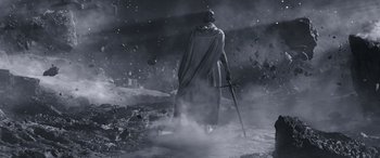 Movie still from “Thor: Love and Thunder” (2022), directed by Taika Waititi – A man in a hooded cloak standing in the middle of a field; Wide shot, Low angle