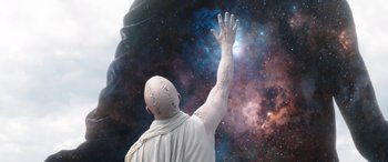 Movie still from “Thor: Love and Thunder” (2022), directed by Taika Waititi – A man in white shirt reaching up into the sky; Medium shot, Low angle