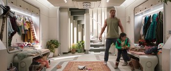 Movie still from “Thor: Love and Thunder” (2022), directed by Taika Waititi – A man and a little girl walking down the hall way; Wide shot, Over the shoulder angle