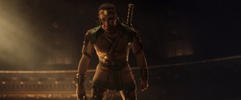 Movie still from “Thor: Love and Thunder” (2022), directed by Taika Waititi – A man with a sword standing in a dark room; Medium shot, Low angle