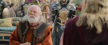 Movie still from “Thor: Ragnarok” (2017), directed by Taika Waititi – An old man with long white hair and a white beard; Medium shot, Over the shoulder angle