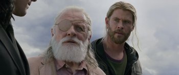 Movie still from “Thor: Ragnarok” (2017), directed by Taika Waititi – Two men standing next to each other in front of a cloudy sky; Close Up shot, Low angle