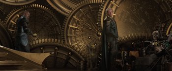 Movie still from “Thor: Ragnarok” (2017), directed by Taika Waititi – A man standing in front of a large metal object; Wide shot, Low angle