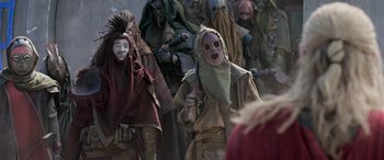 Movie still from “Thor: Ragnarok” (2017), directed by Taika Waititi – A group of people dressed in costumes and masks; Medium shot, Over the shoulder angle